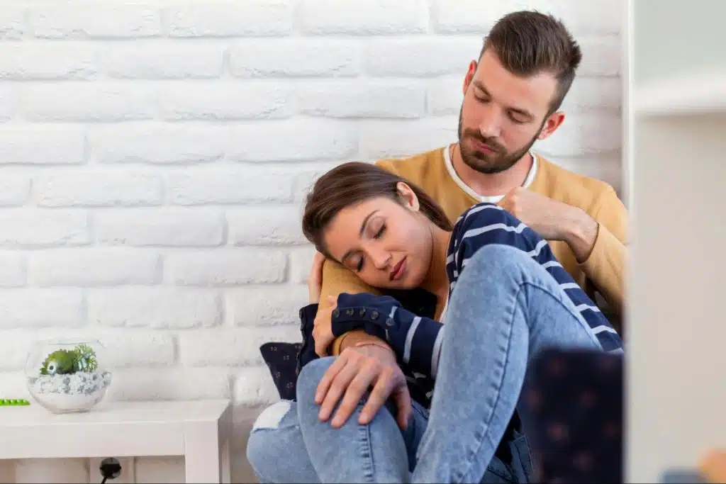 A man looking at the woman sleeping peacefully