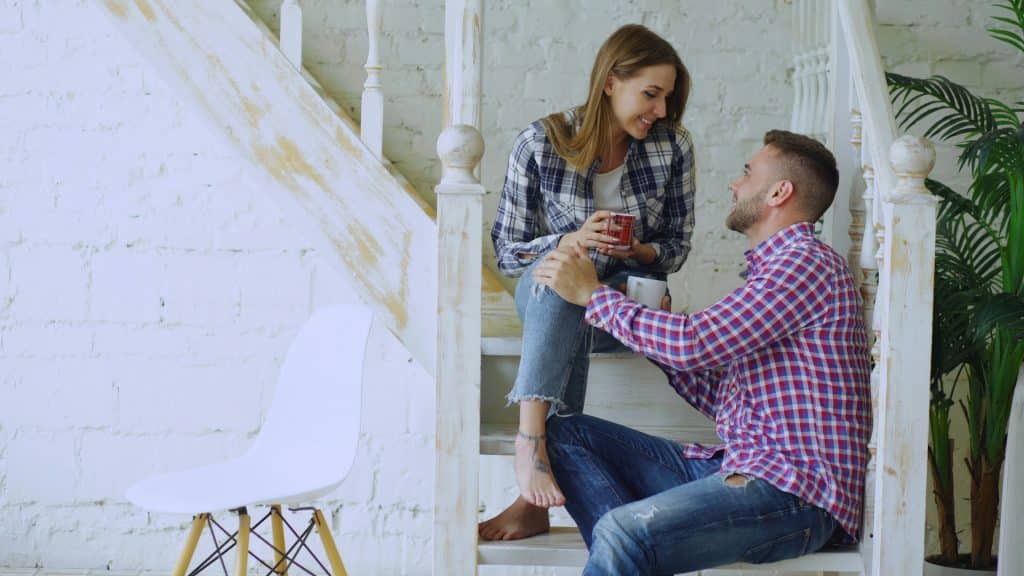 A couple talking on a staircase.