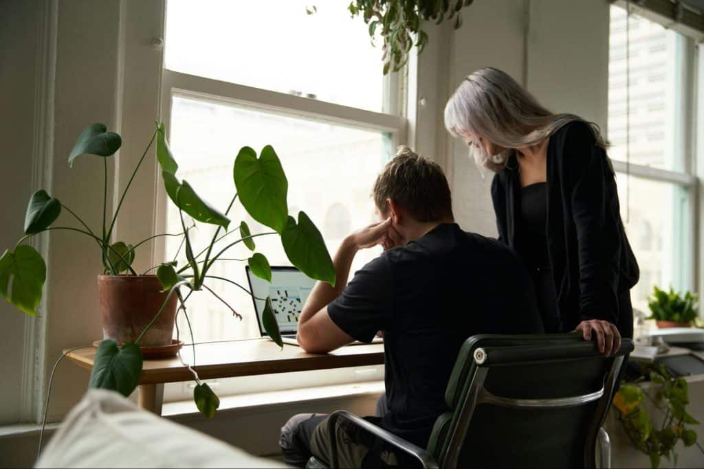 A man and woman checking their bill payments
