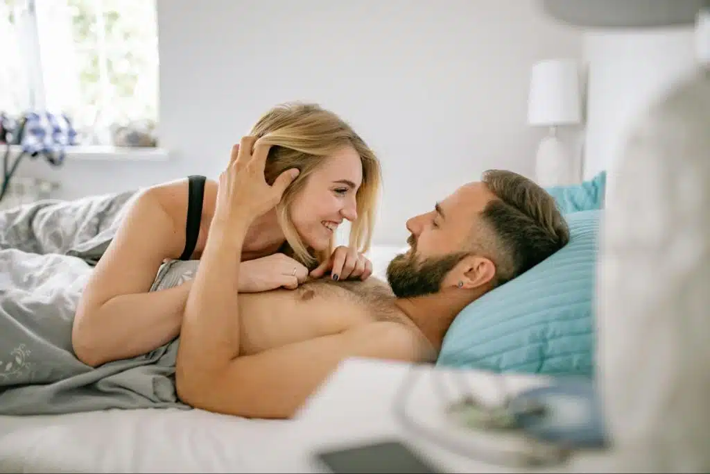 A man and woman at the bed