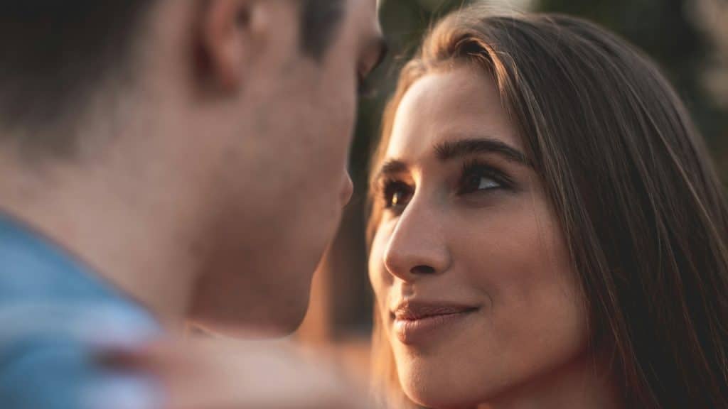 The young girl is looking at the man with true love and care; she is enjoying his company.