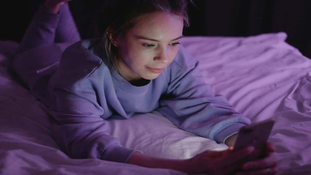 A woman texting at night 