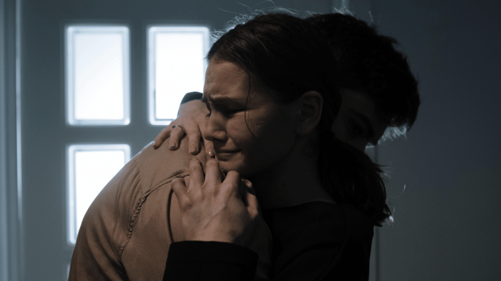 A couple crying while hugging
