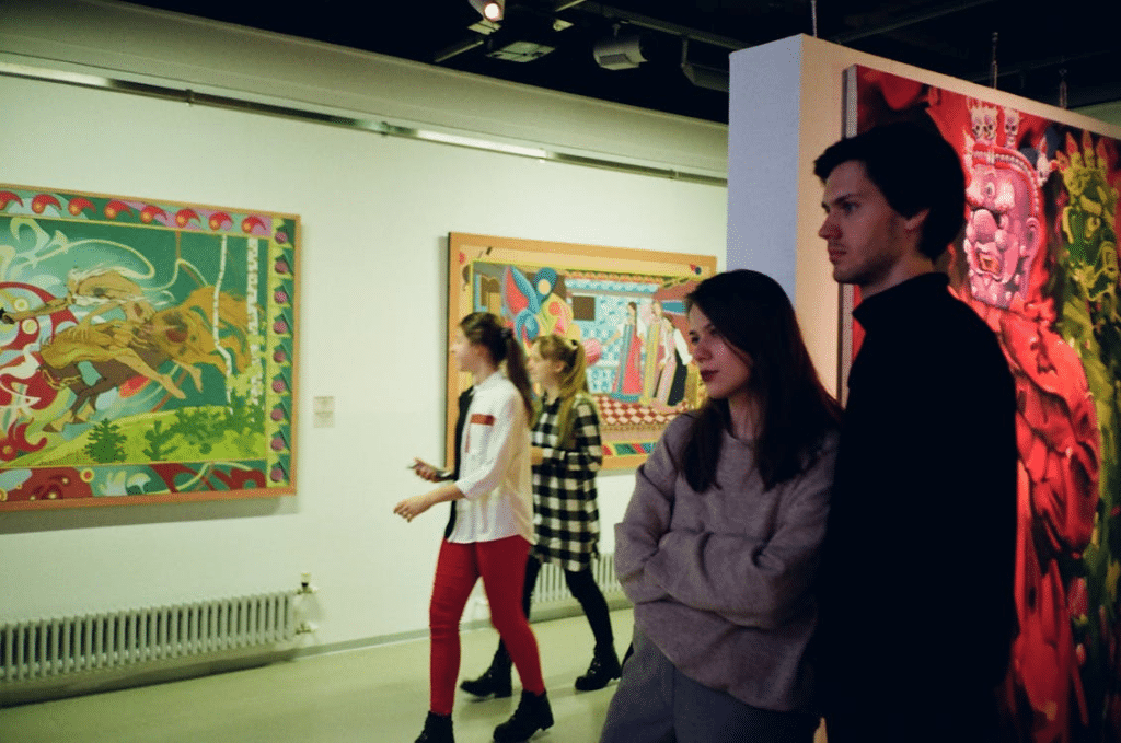 A man and a woman looking at a painting