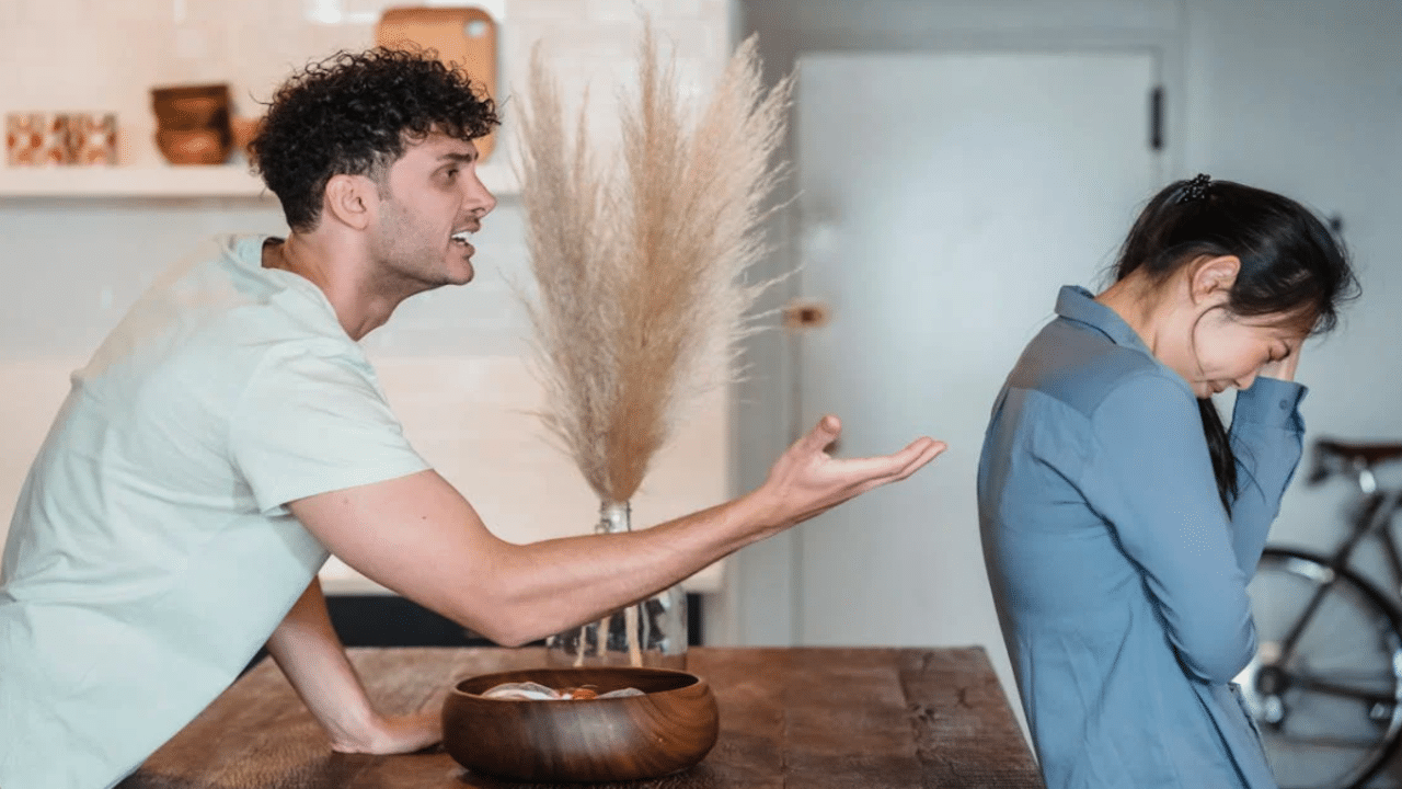 A couple fighting in the kitchen