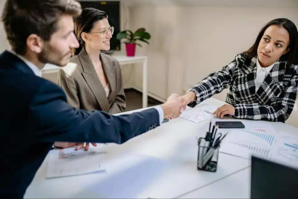 A man and woman meeting with their colleague
