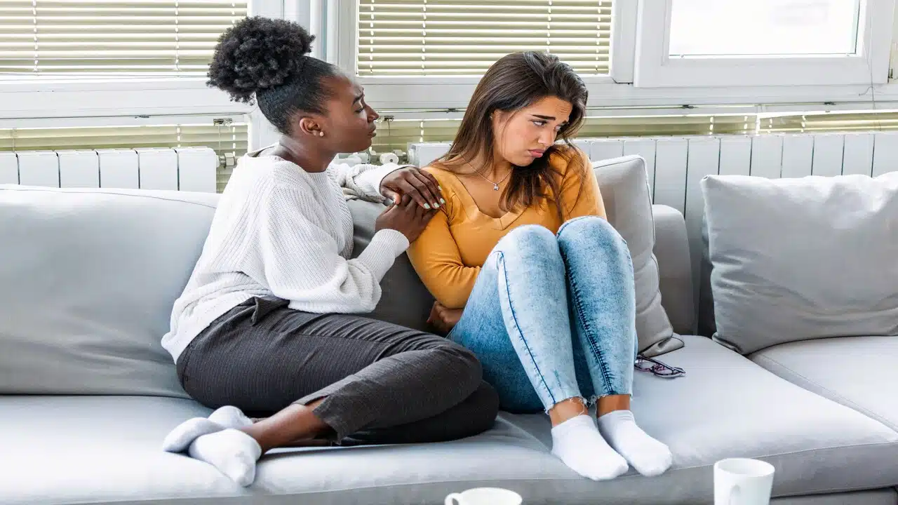 A woman comforting her sad friend