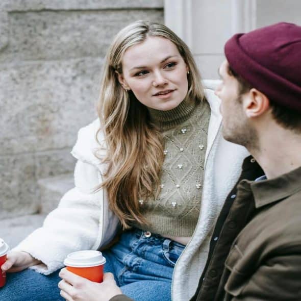 A couple talking by the sidewalk
