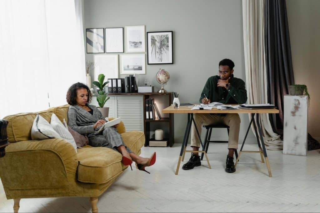 A man and woman at the same room but not talking to each other