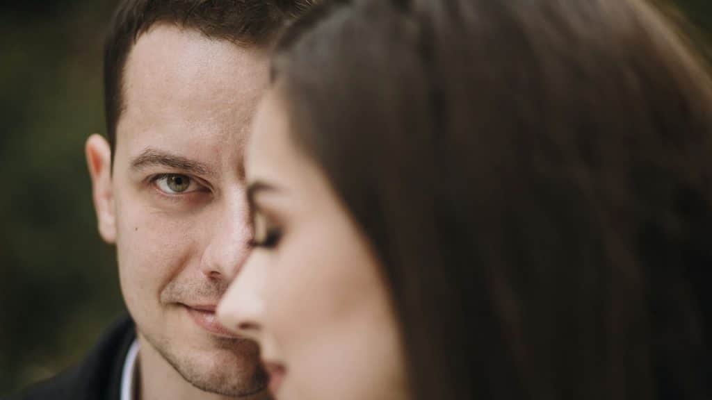 A man staring at a woman and smiling.