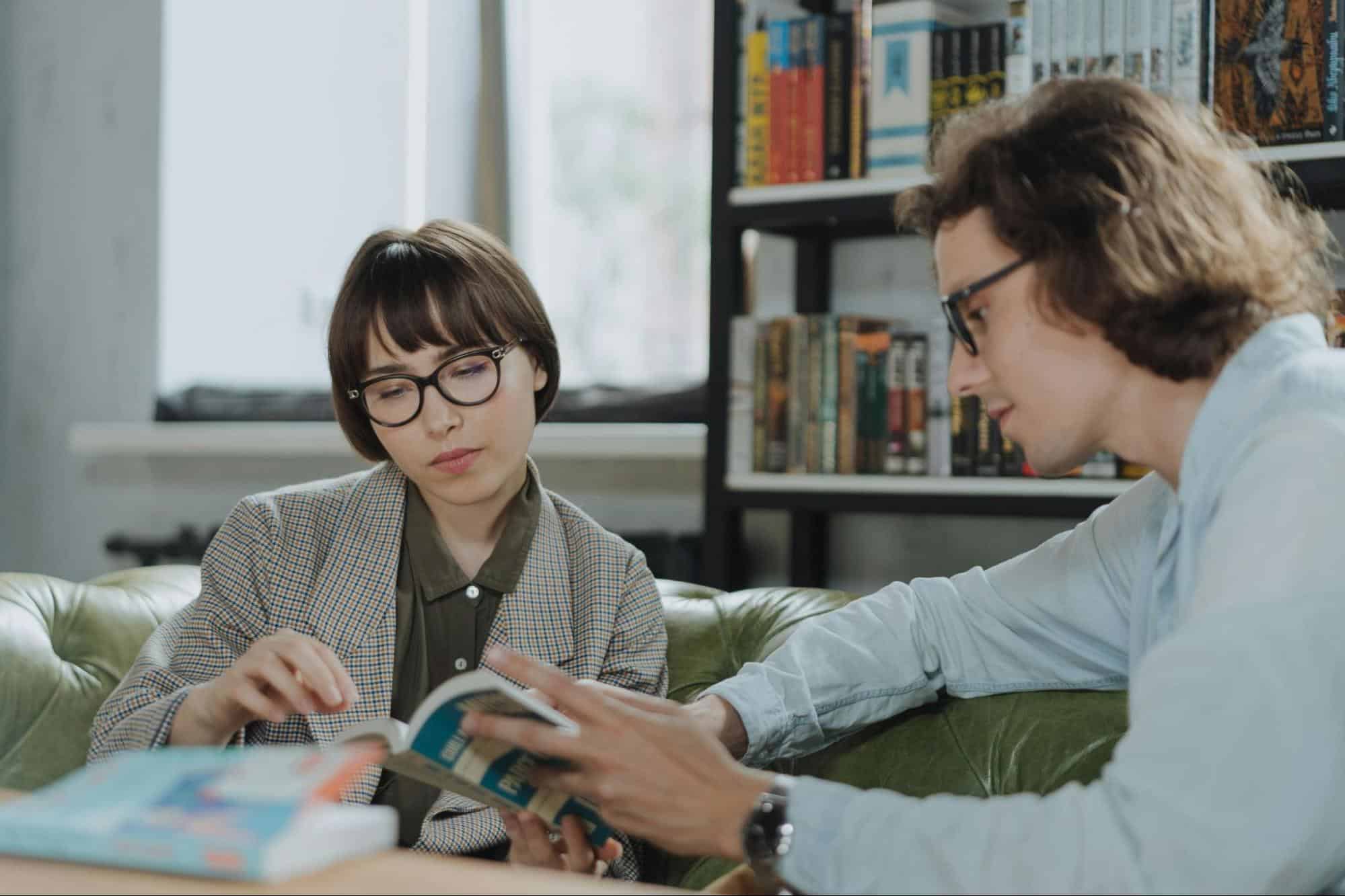 A man and a woman reading a book