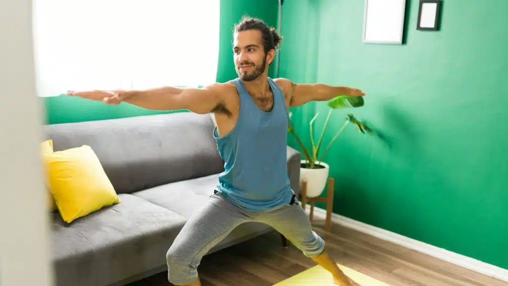 A young man doing exercise at home.