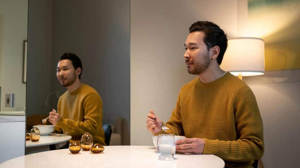 A man eating alone at home.