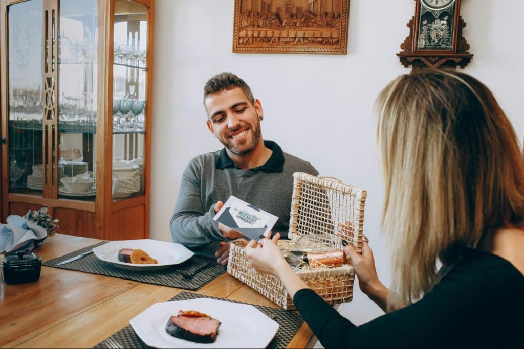 A man opening the gift for woman
