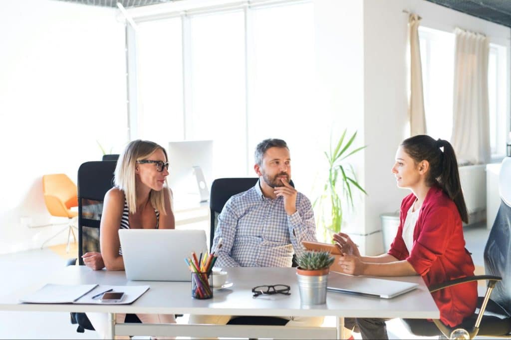 One man and two women at the office