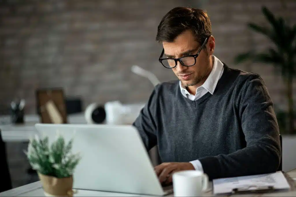 A man looking at his laptop