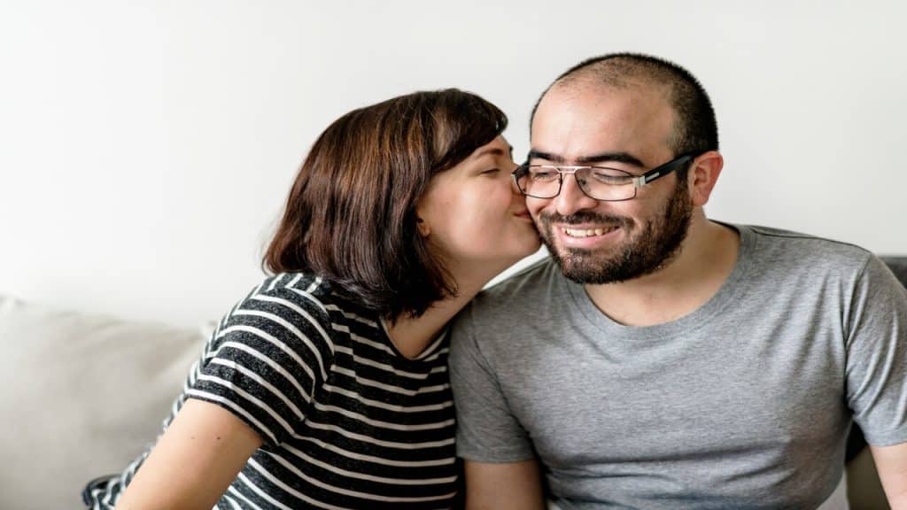A woman kissing her husband