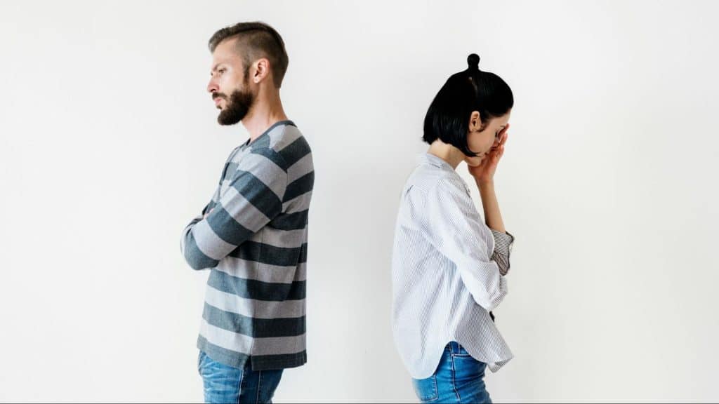 A man and woman facing away from each other