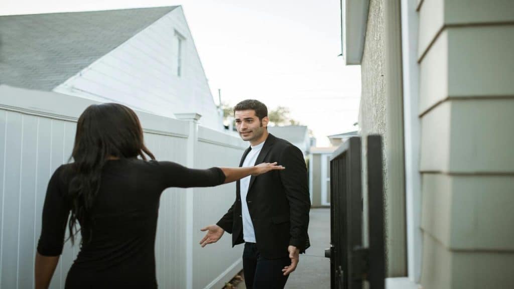 A couple fighting outside their home