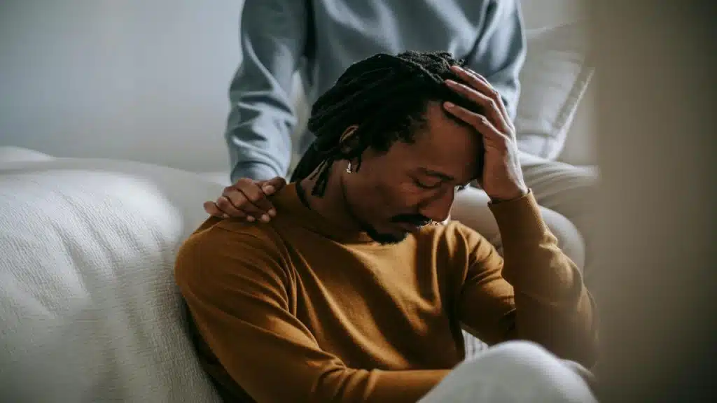 A woman comforting her sad husband