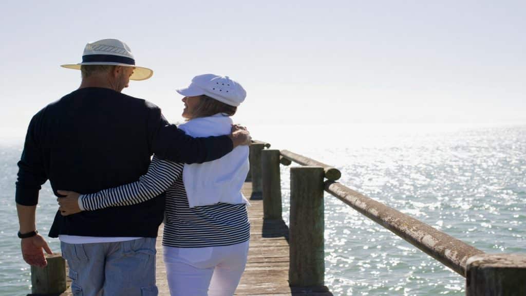 A couple walking on a pier