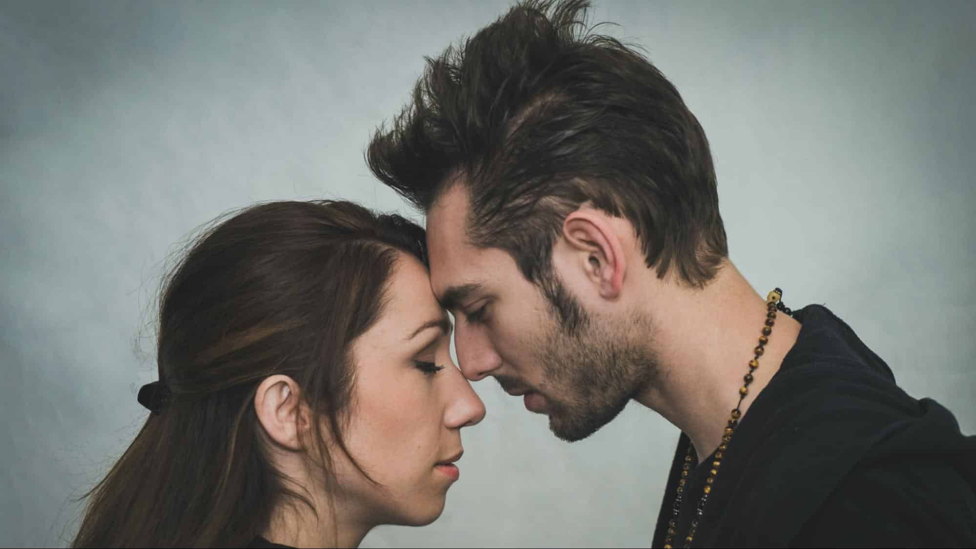 A man and woman closely facing each other