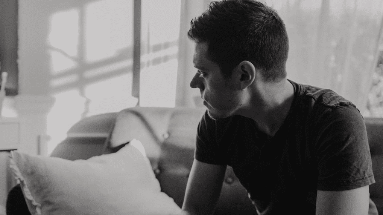 A man deep in thought at home