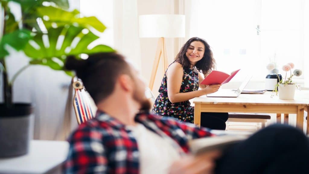 A couple smiling at each other at home