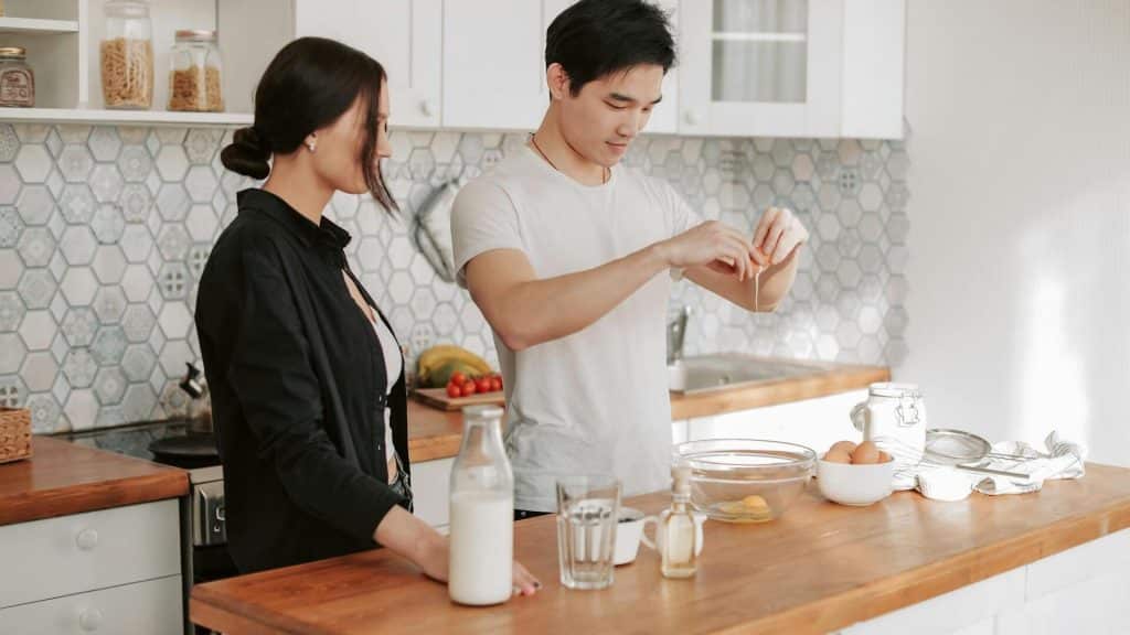A couple preparing food in the kitchen.
