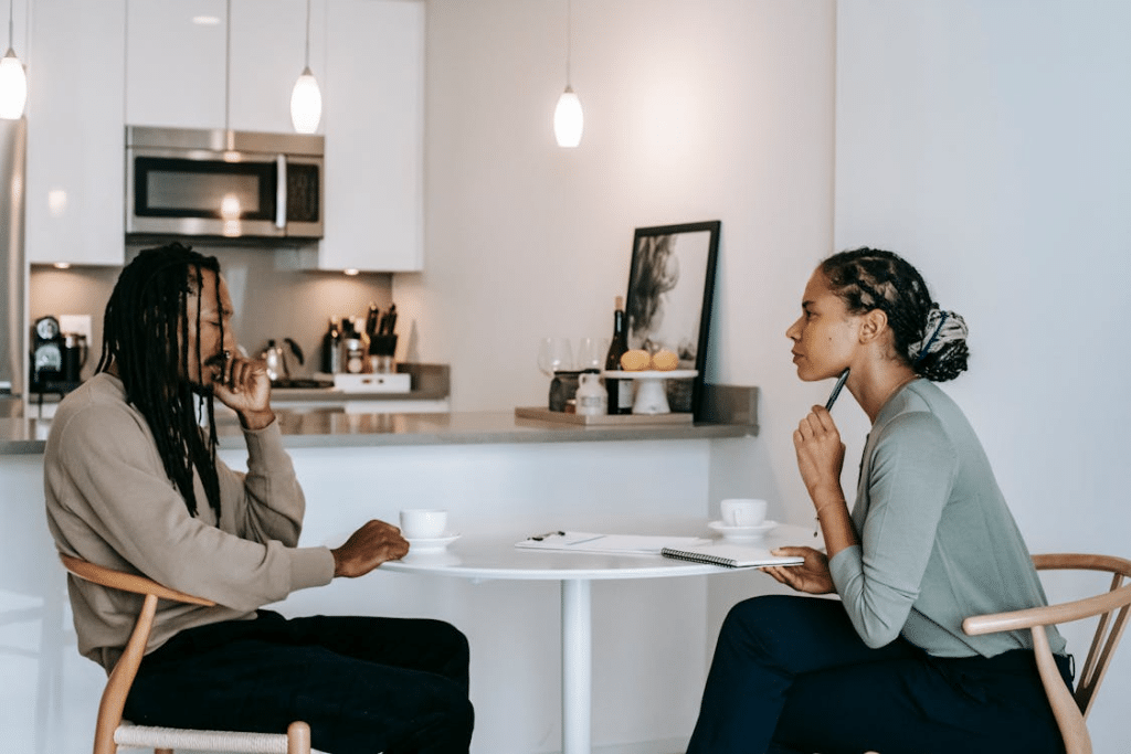 Frustrated man sharing problems with attentive female