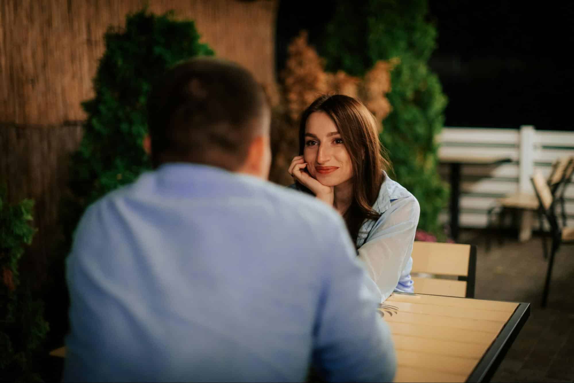 A woman smiling at the man