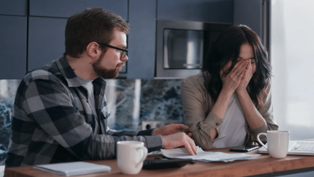 A couple looking stressed at their bills