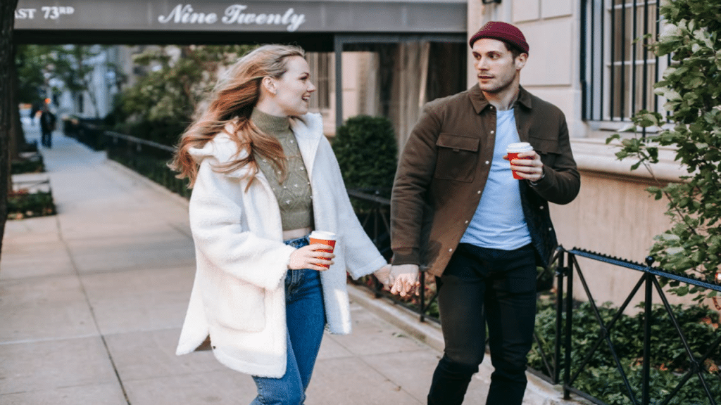A couple walking on a sidewalk