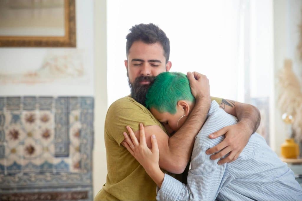 A man hugging a woman