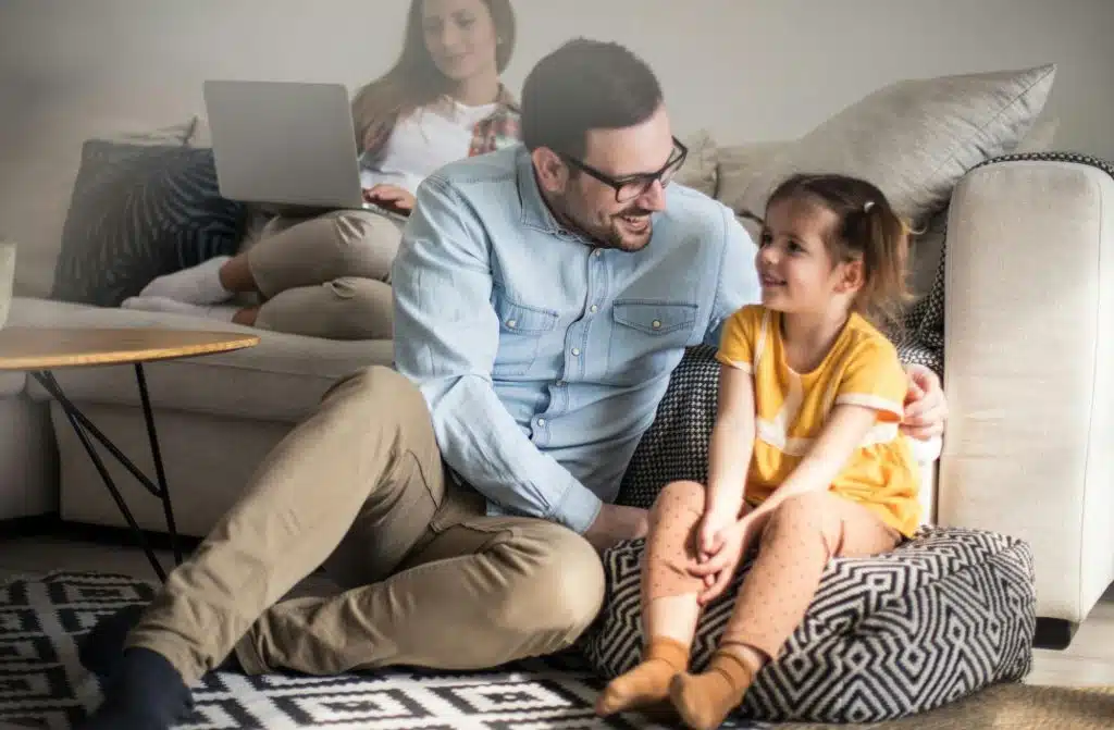 A man teaching his daughter