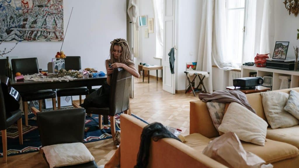 A sad woman sitting at the dining table