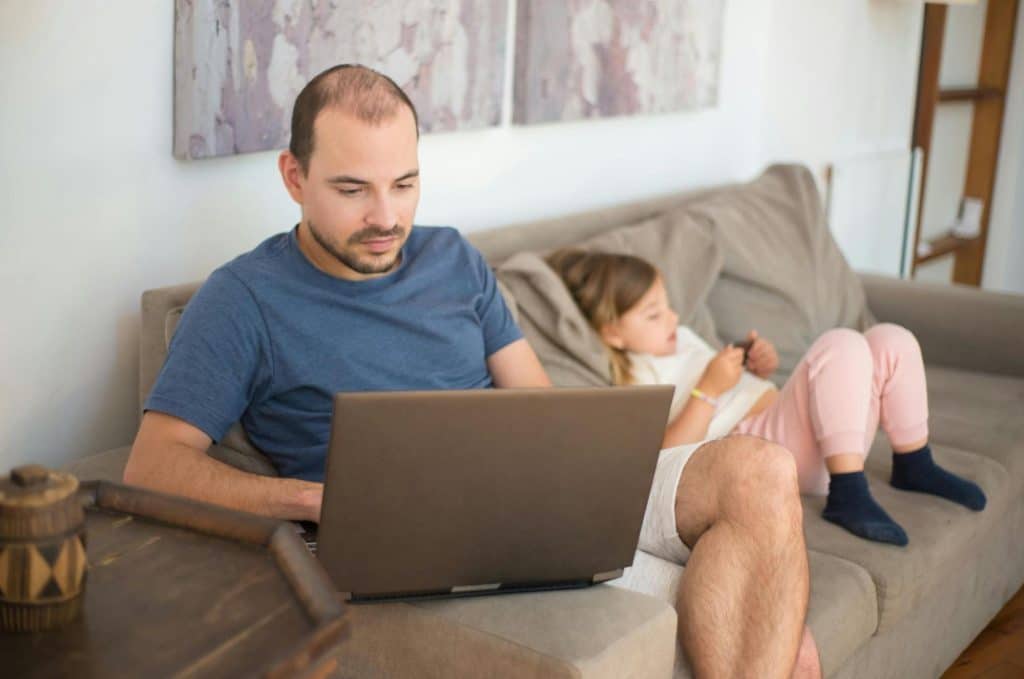 A man working beside his daughter 