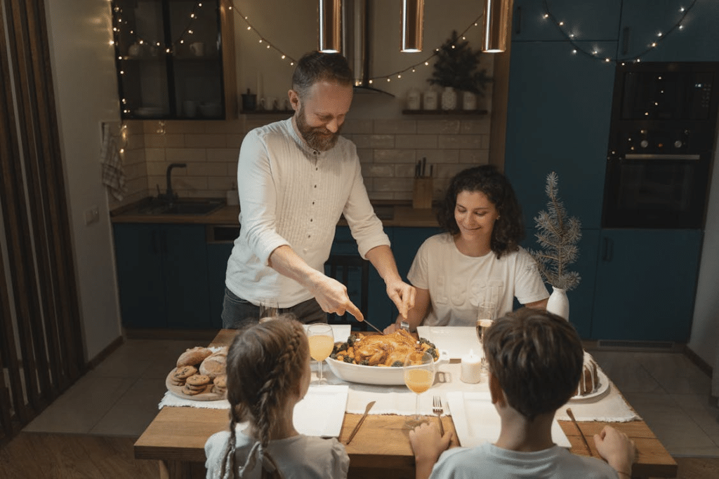 A father cutting a roasted turkey