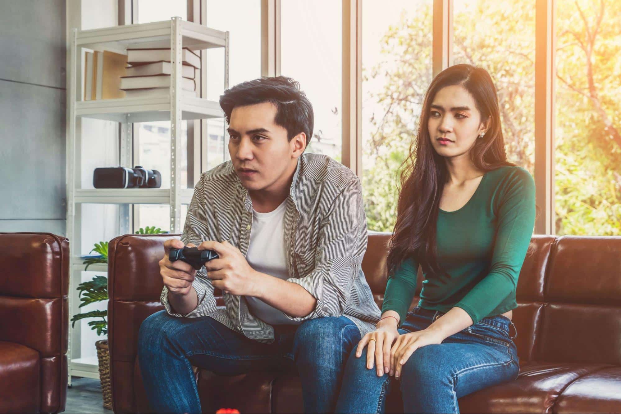 A man busy playing and a woman looking at him