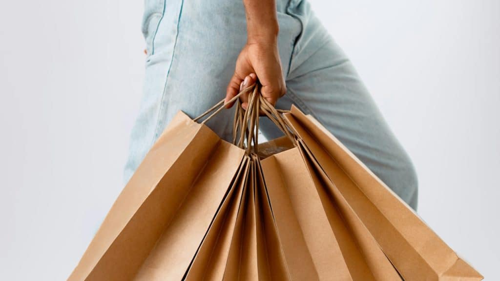 A man carrying different shopping bags.
