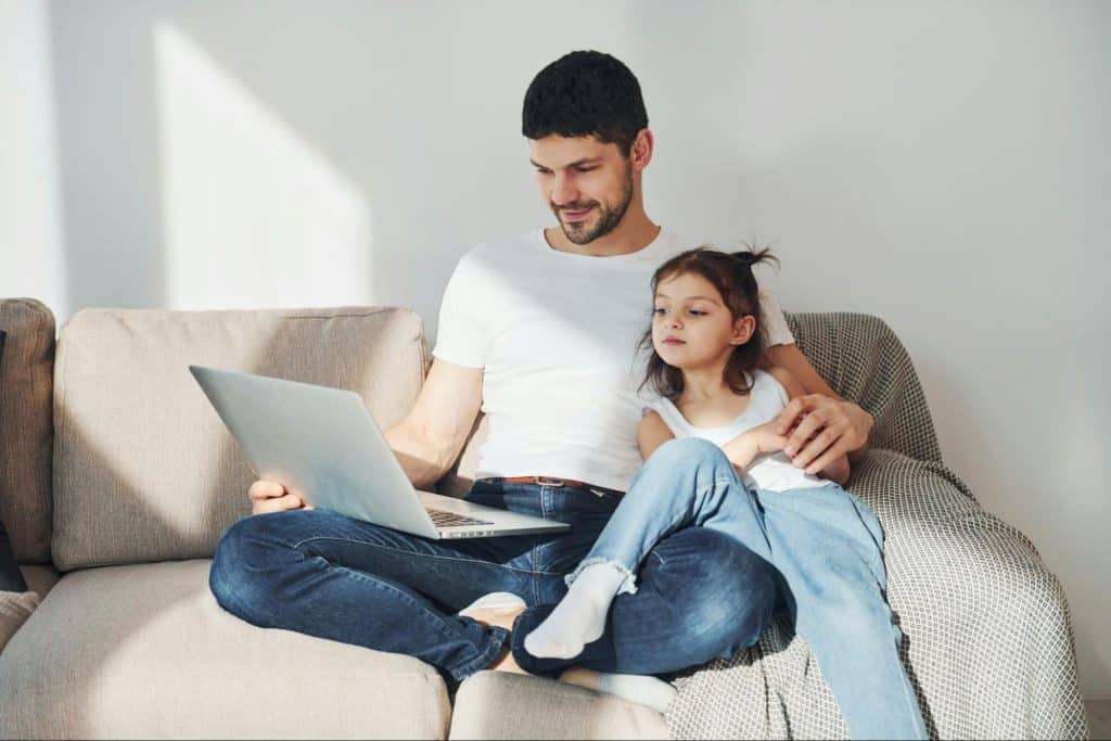 A man working while his daughter waits for him