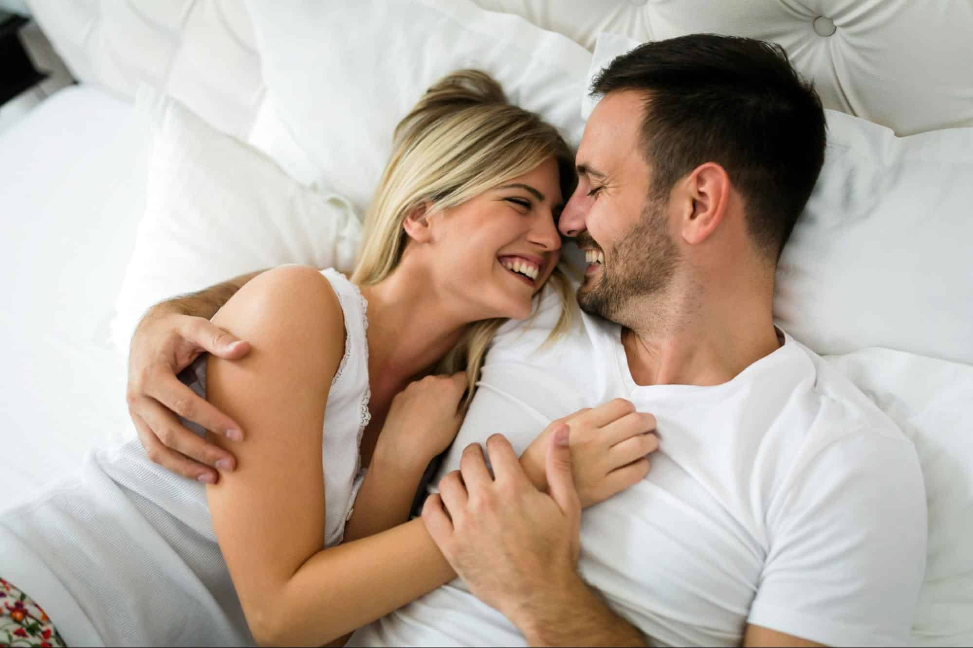 A man and woman at the bed