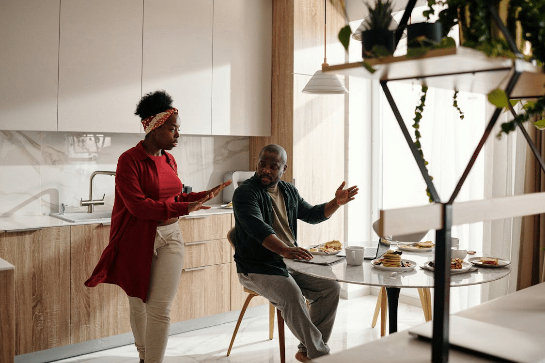 A couple arguing in the kitchen