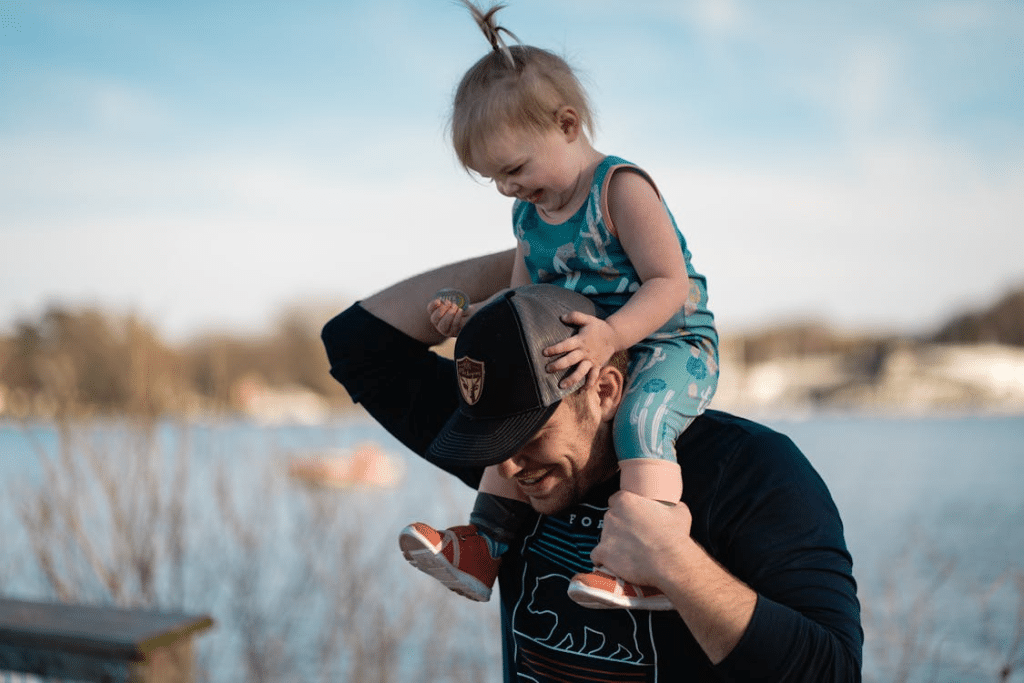 A man carrying his daughter