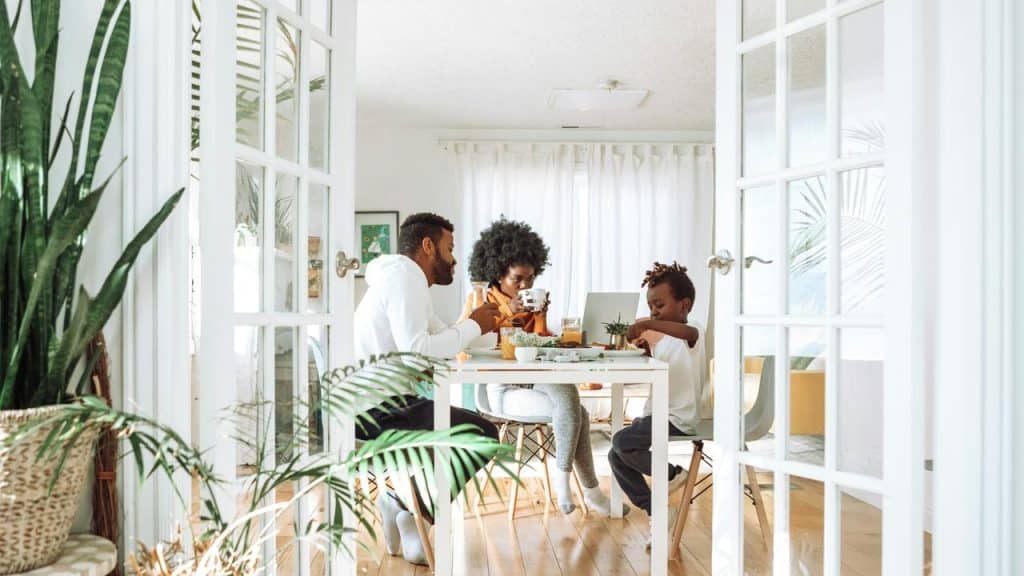 A family sharing a meal together at a bright dining table.
