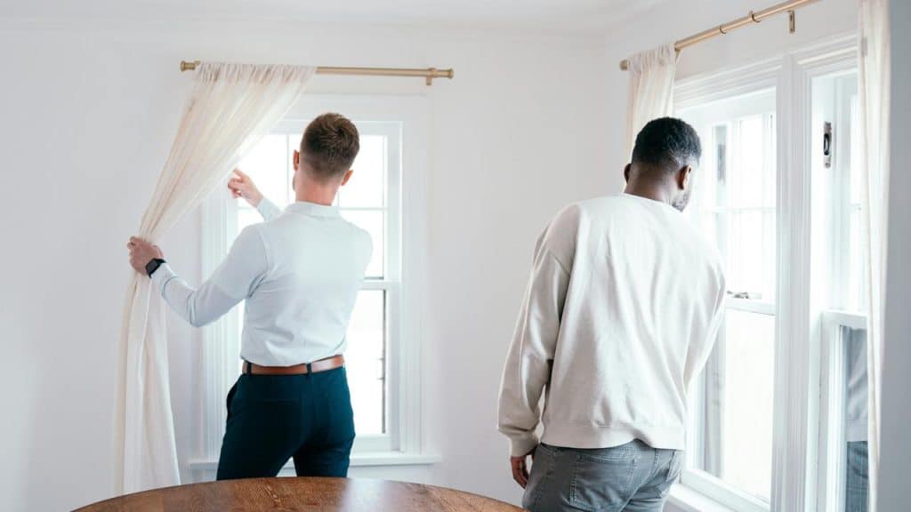 A real estate agent showing windows to a client.