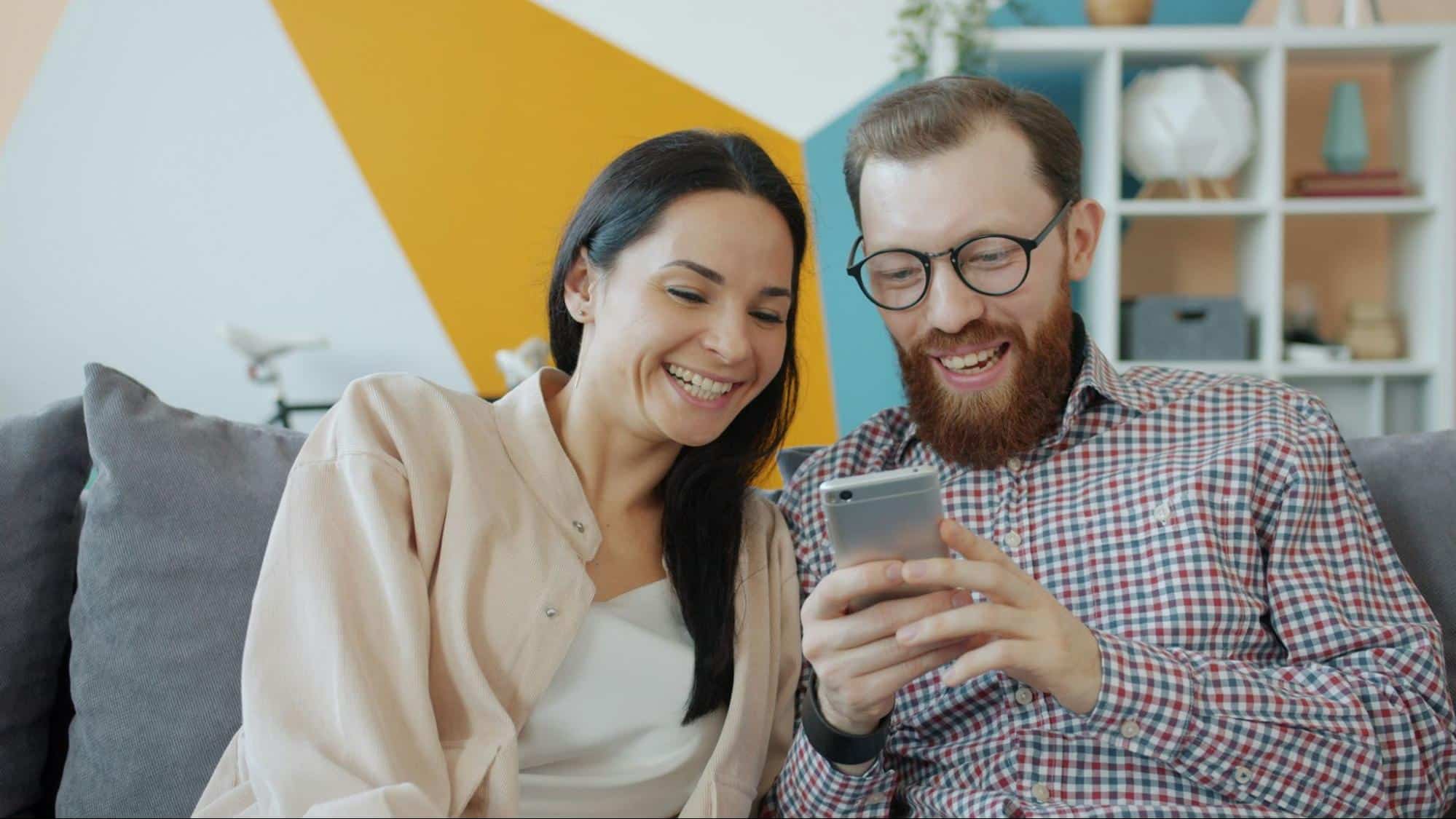 A man using a phone and a woman beside him