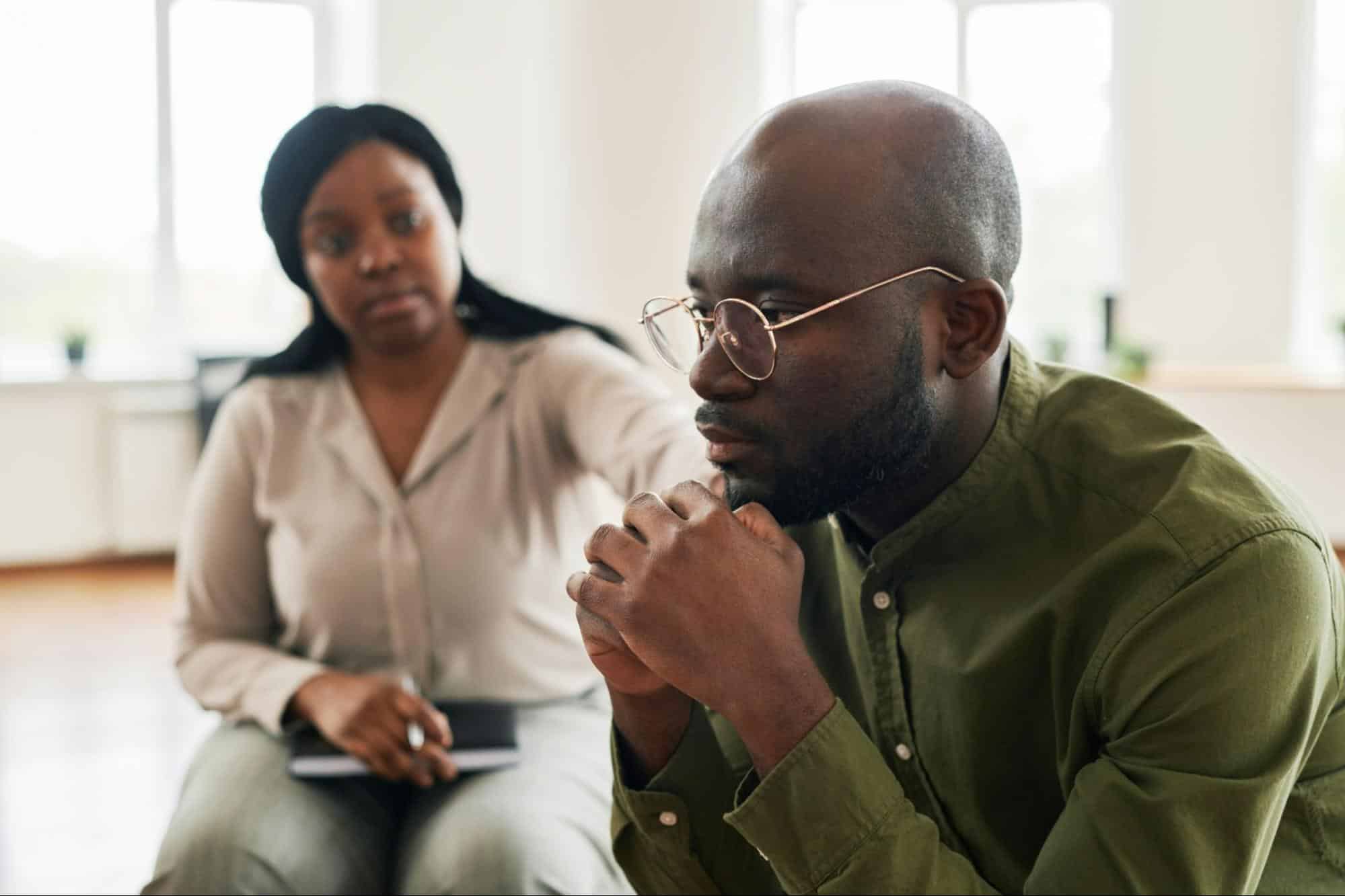 A man thinking and a woman beside him