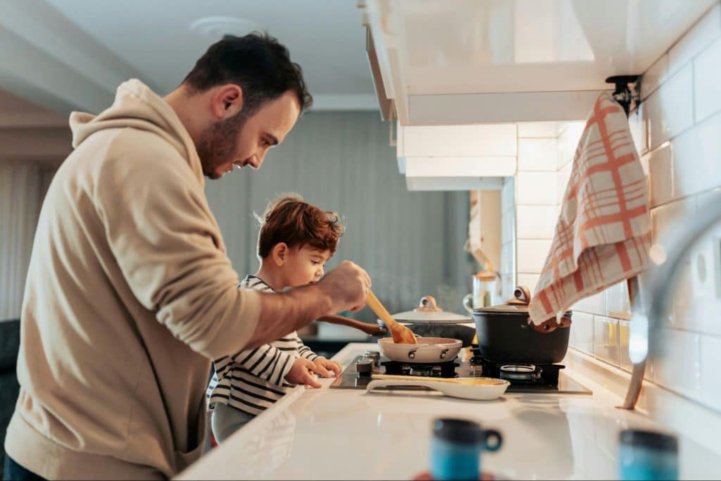 A man with his child at the kitchen