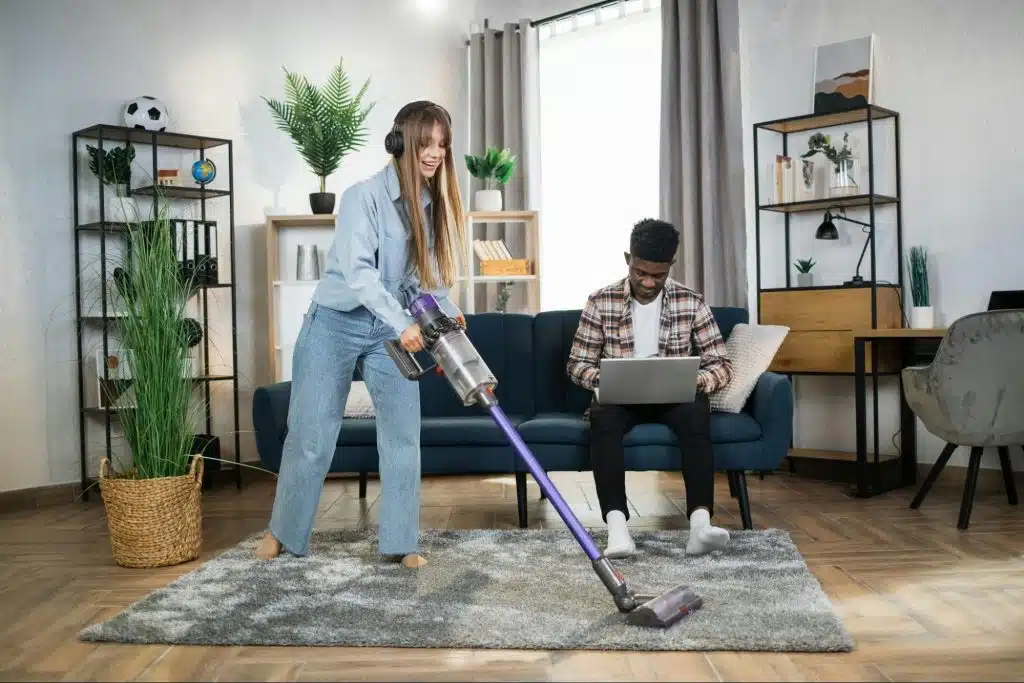 A man busy working and a woman cleaning